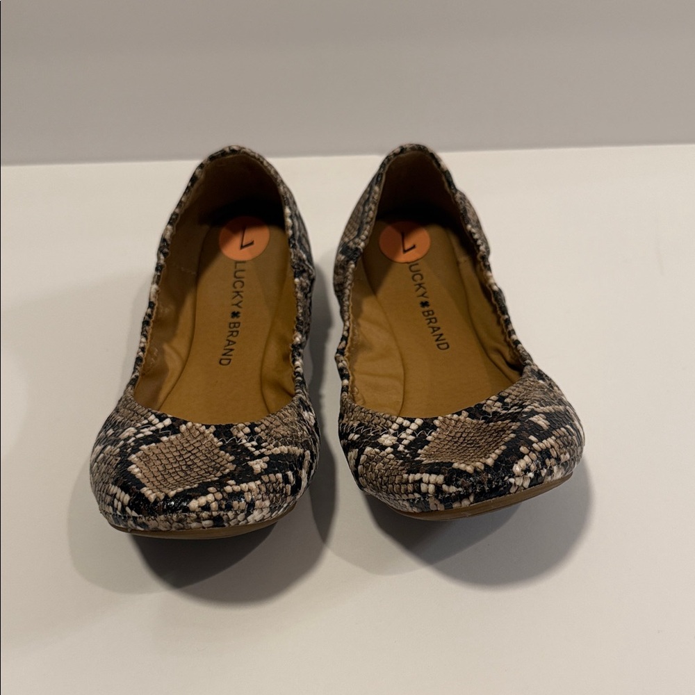 53.  Lucky Brand Women's Black and Cream Snake Pattern Flats.